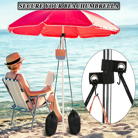 2 Pack Large Beach Umbrella Sand Bags Heavy Duty Waterproof Counterweights for Umbrella Bases and Tents Each Holds About 60 Lbs Includes Straps and S Hooks Portable Canopy Weight Kits for Outdoor Shade securing a red umbrella on a beach with a woman reading nearby.