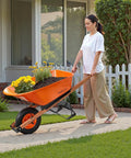 Woman using One Wheel Dump Cart For Garden And Yard, 6 Cu Ft Capacity, 330 Lb Load, Built Tough Wheelbarrow With Metal Handle