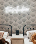 It Was All a Dream Neon Sign Lit Flexible LED Neon Light with custom logo above twin beds, white back plate, decorative pillows