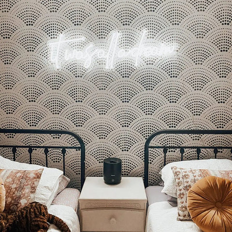 It Was All a Dream Neon Sign Lit Flexible LED Neon Light with custom logo above twin beds, white back plate, decorative pillows