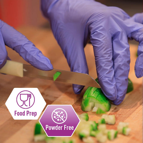 Person wearing Powder Free Nitrile Exam Gloves Iris Blue Medium Box Of 100 For Medical Labs Hospitals And Professional Use slicing cucumber.