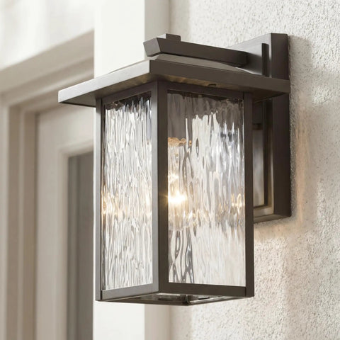 Capanna 1-Light Outdoor Wall Light in Olde Bronze with Clear Water Glass on white wall, classic modern vibe, wet rated design