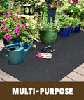 Oil Spill Mat For Garage Floor 3 By 7 Feet Under Motorcycle Waterproof Durable Non Slip TPR Backing Reusable Absorbent Pad Charcoal Heavy Duty Oil And Water Drip Catcher For Workshop And Garage placed on wooden deck with gardening tools and plants.