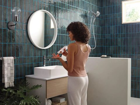Modern bathroom with a woman near Aromatherapy Hand Shower With INLY Technology And Spa Capsule Kit, chrome finish visible