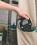 Hand holding Badass Portable Label Maker Featuring Authentic Qwerty Keyboard And Rapid Response Touch Keys in a pocket.