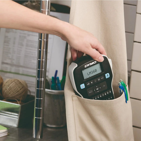 Hand holding Badass Portable Label Maker Featuring Authentic Qwerty Keyboard And Rapid Response Touch Keys in a pocket.