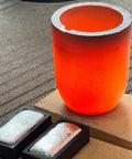 Heavy Duty Graphite Crucible With Smooth Pouring Spout For Melting Aluminum Up To 1800 C Heat Resistant Foundry Pot with molten metal bars.