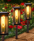 Outdoor Solar Pathway Lights Six Pack Waterproof LED Filament Lamps illuminating garden path with flowers at night