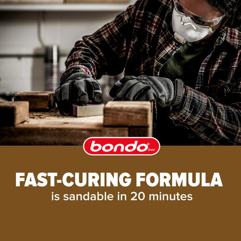 Person using The Real Deal Wood Filler Kit 30 Oz With Quick Set Hardener on wood, sanding it smoothly for repair work.