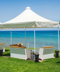 Heavy Duty Sand Bags For Canopy Legs Set Of 4 Empty Weight Bags beside pop-up tents by the ocean, securing shade structures.
