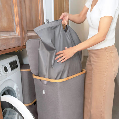 Breathable Fabric Laundry Hamper With Lid, Bamboo Frame, Side Handles, 26 Gallon Gray Go-To Laundry Basket in use in laundry room