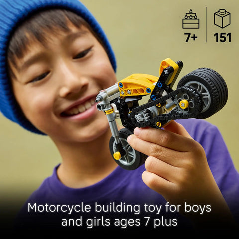 Child holding Technic Yellow Motorcycle Building Kit for Kids 7 and Up with Realistic 3 Piston Engine and a Working Rear Wheel 42225.