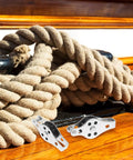 Close-up of Stainless Steel Boat Pulley Wheel 2 Pack For Kayaks And Sailboats, shown with ropes on deck