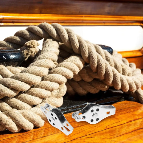 Close-up of Stainless Steel Boat Pulley Wheel 2 Pack For Kayaks And Sailboats, shown with ropes on deck