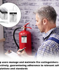 Man inspecting fire extinguisher with 25 Pack Fire Extinguisher Inspection Tags With Waterproof Plastic Covers and aluminum tags