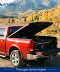 Red pickup truck with open fiberglass tonneau cover supported by 27 Inch 45lb Gas Strut For Fiberglass Tonneau Cover And Pickup Truck Bed
