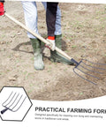 Person using Beefy Heavy Duty Manure Fork For Farm And Garden on dirt, lightweight iron pitch fork with durable design for yard cleanup.
