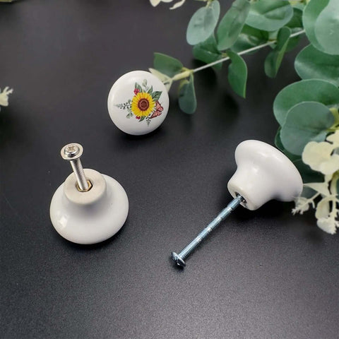 Kick Up Your Rustic Style With Eight Darn Cute Ceramic Kitchen Cabinet Drawer Knobs Featuring Pretty Sunflower And Butterfly Art For Dressers And Cupboards Designed For Smooth Grip Easy Install And Farmhouse Vibes, close-up view of sunflower knob with screw.