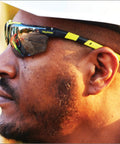 Sick Clear Vision Transition Safety Glasses With Anti Fog Coating And Scratch Resistant Lenses Featuring Adjustable Non Slip Fit For Legit All Day Comfy ANSI Certified Protection worn on a man's face outdoors.