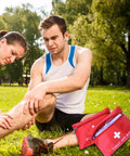 Red 12 Pack Empty First Aid Pouches for Travel and Outdoor Use Grab and Go Medical Bags next to an injured person in a park