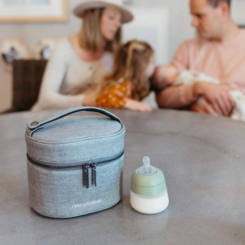 Keep It Chill On The Fly Breastmilk Bottle Cooler Travel Bag With Included Freezing Insert Compact Triple Layered Thermal Carrier on a table.
