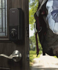 Touchscreen Smart Door Lock With Keypad And Bluetooth Motorized Deadbolt One Tap Entry Easy Setup Remote App Control See Who Entered And When 20 Unique Access Codes Black DB1 installed on door with person nearby