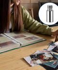 A person examining photos next to a scrapbook using Heavy Duty 20 Piece Scrapbook Extension Posts And Bookbinding Screws Rust Proof Copper 12 Millimeter Spacer Rings For Plug And Play Photo Album Refills No Fuss Craft Supply Kit.