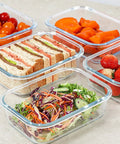 Five 30 Oz Glass Meal Prep Containers Set Of Five With Lids Durable Glass Storage For Lunches And Leftovers Dishwasher Safe Microwave Safe Oven Safe Freezer Safe Portion Control Containers For Everyday Meal Prep filled with fresh food on counter.