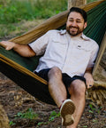 Man relaxing in Double Deluxe Hammock 11 Ft Long, 500 Lb Capacity, Ultra Light Packable Ripstop Nylon For Hiking, Camping, And Travel