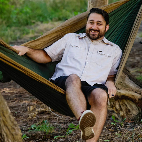 Man relaxing in Double Deluxe Hammock 11 Ft Long, 500 Lb Capacity, Ultra Light Packable Ripstop Nylon For Hiking, Camping, And Travel