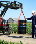 Shop Floor Ready Heavy Duty Fifty Five Gallon Drum Lifting Sling With Twin Adjustable Ratchet Straps used with a forklift in a field.