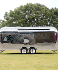 Lightweight Mobile Food Trailer With Full Plumbing And Electrical Wiring Solid Rig For Your Downtown Block Party Or Street Food Hustle Ready To Roll Smooth Today, silver exterior in a grassy area.
