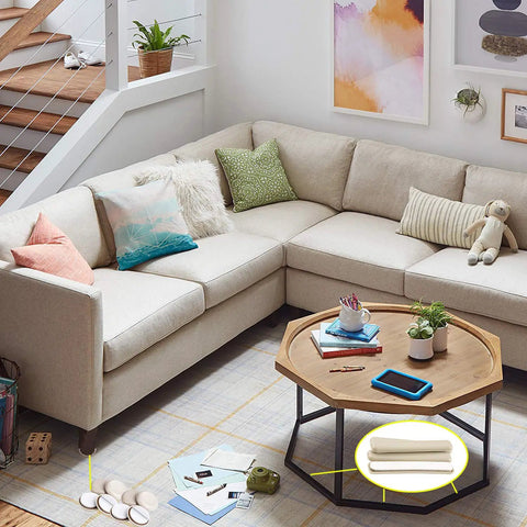 Living room with sectional sofa, coffee table, and 32 Pcs Self Stick Carpet Sliders Half Inch By 4 Inch Self Adhesive Furniture Moving Pads for Carpet Floors.