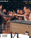 People celebrating at night with a wood grain brown 80-quart rolling party cooler with divider, holds 110 cans, wicker shelf, durable design for backyard parties.