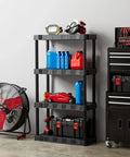 Heavy Duty Four Tier Plastic Storage Shelving Unit In Black, 13.9 Deep By 30 Wide By 56.2 High next to tools and fan in garage