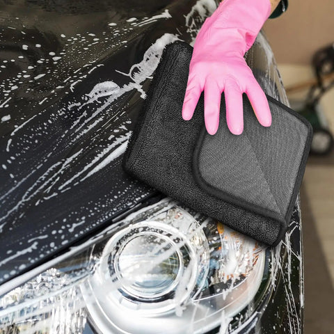 Person using Super Absorbent Microfiber Car Drying Towel Thickened Lint Free Auto Wash Cloth on a soapy car hood.