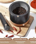 Durable Granite Mortar And Pestle Set With Wood Base For Grindin Herbs And Spices, Perfect For Guac And Salsa, Pepper And Nuts, Heavy Duty Stone Crusher For Home Kitchen Use on wooden board with spices
