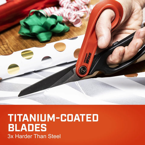 Close-up of Heavy Duty 10 Inch Titanium Coated Tradesman Shears with serrated blades cutting wrapping paper.