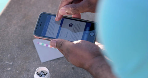 User checking pool chemical readings on a smartphone using Six Way Pool Water Test Strips For Rapid Chemical Readings With Seamless App Sync To Keep Your Backyard Hangout Sparkling All Summer Long Without Any Headaches Or Sticker Shock From Costly Store Visits.