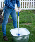 Portable Manual Clothes Washer Plunger working as a smooth washing agitator in bucket full of suds outdoors.