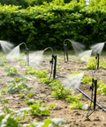 360 Degree Adjustable Misting Heads With Stakes 15 Pack For Garden Irrigation System, showing misting in a garden plot