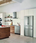 Modern kitchen with a built-in stainless steel refrigerator and oven, featuring wooden cabinets and a large island