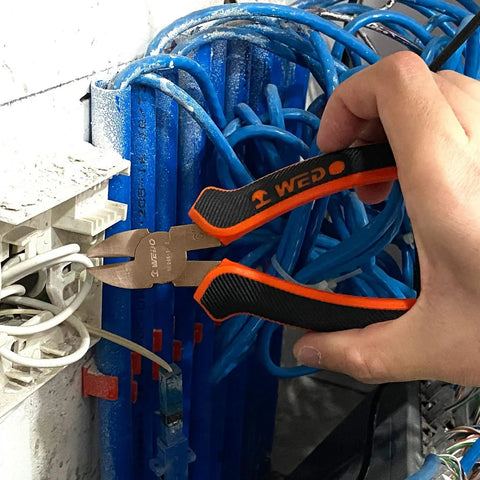 Close-up of hand using wire cutter from Non-Sparking Tools Set 37-Piece Pro Grade Spark Free Safety Kit on electrical wires.