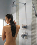 Person in modern bathroom under 16 Inch Black Stainless Shower Arm Trim With One Half IPS Threads, Wall Mount Design For A Fresh Shower Upgrade, Durable Finish That Lasts, Flange And Shower Head Sold Separately