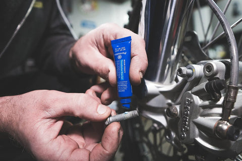 Applying Blue Medium Strength Threadlocker For Quick Vibration Control And Leakage Prevention Seals And Prevents Rust on bolt