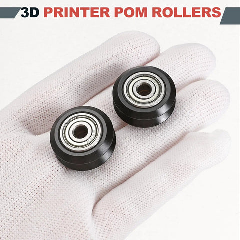POM V Slot Pulley Wheels Set With 625zz Bearings For Slick High Speed Gantry Motion In DIY 3D Printers And CNC Machines 24mm OD 5mm ID 6mm Wide Black Finish, two black wheels on gloved hand