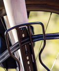 Outpost Cargo Water Bottle Cage With Triple Mount Holes And Straps securing bike frame, showing strap detail and mounting.