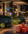 Decorative pathway with crescent moon and star lights, garden landscape, blooming flowers, and red gift boxes on paved path