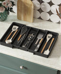 Expandable Kitchen Utensil Organizer for Drawers, Adjustable Cutlery Tray and Spatula Holder, 3 Large Compartments Plus Side Expandable Slots shown on countertop