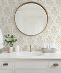 Beige Floral Peel And Stick Wallpaper With Delicate Arched Accents on bathroom wall with round mirror and plant.